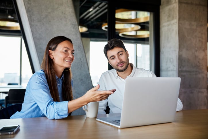 Two people discuss a project they need translated.