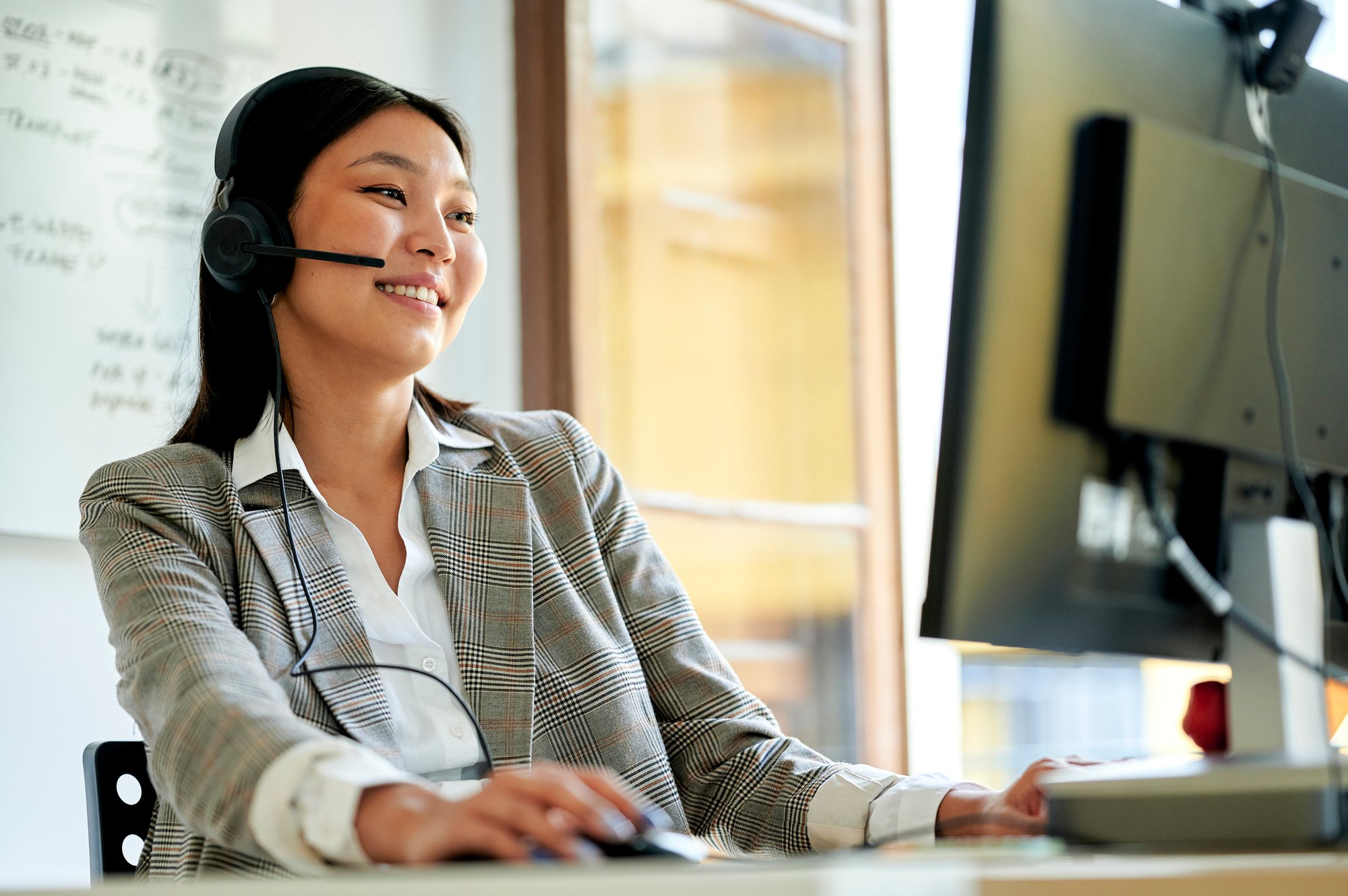 An interpreter smiles as she helps a business client.