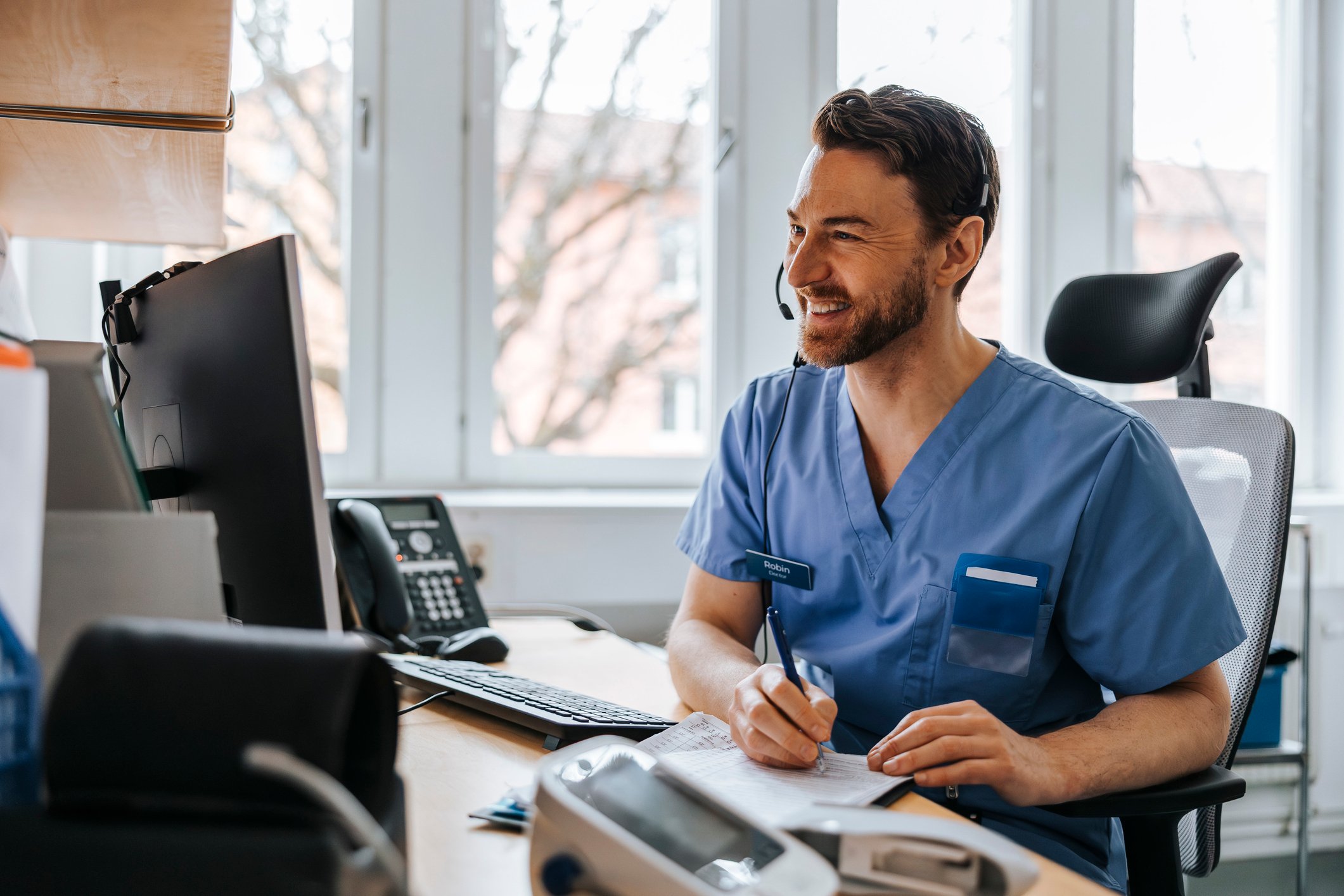 A healthcare worker smiles as he submits a translation request.
