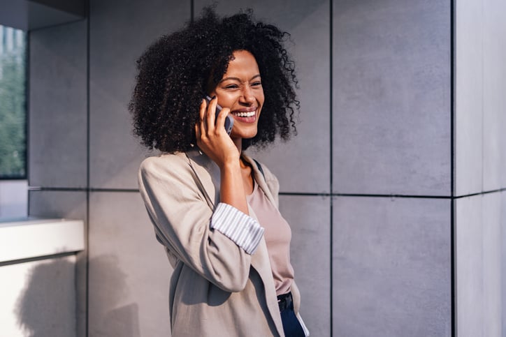 A hospitality worker answers a call with an interpreter on the line.