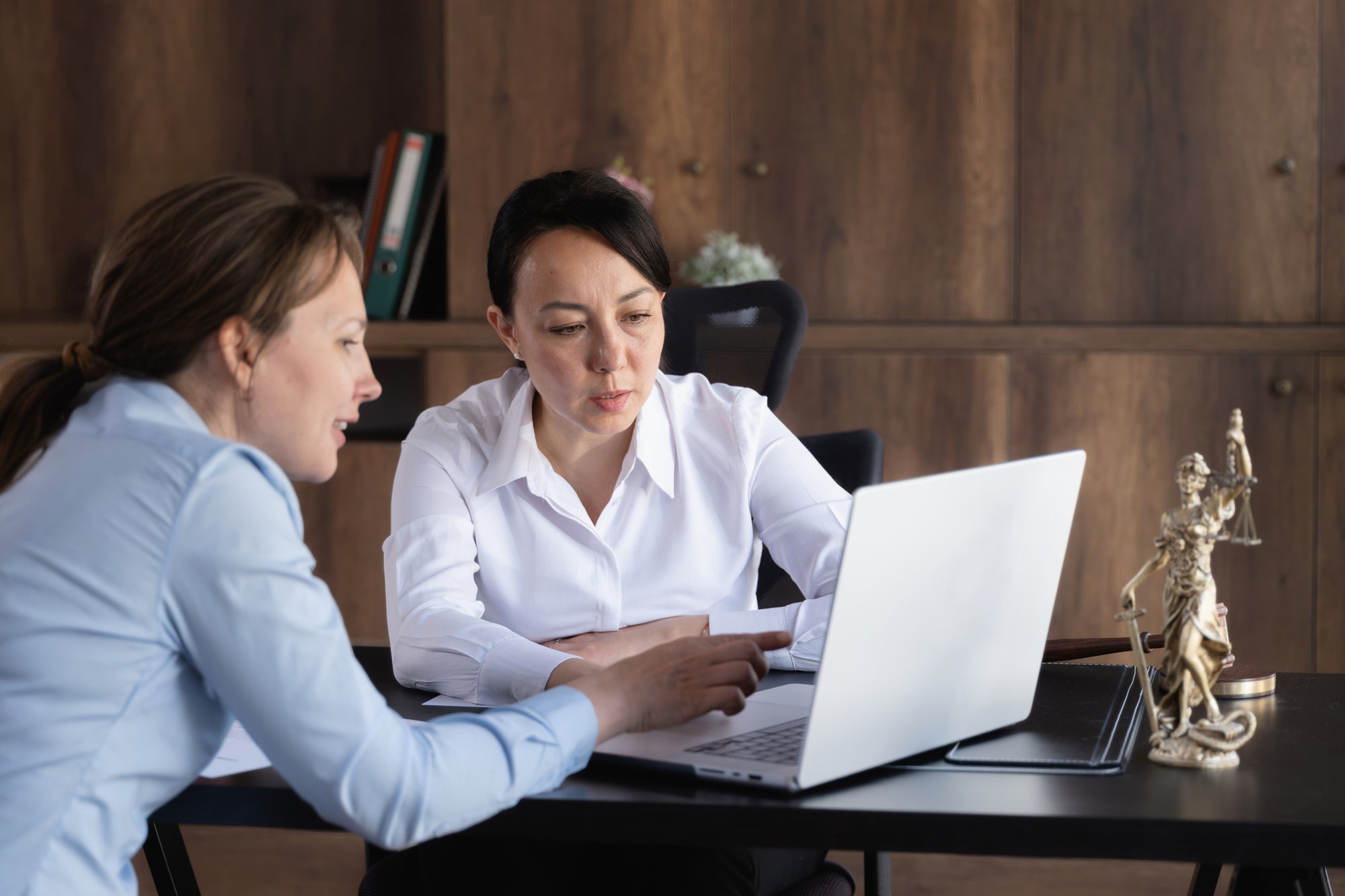 A lawyer and her client look at an electronic translated legal document together