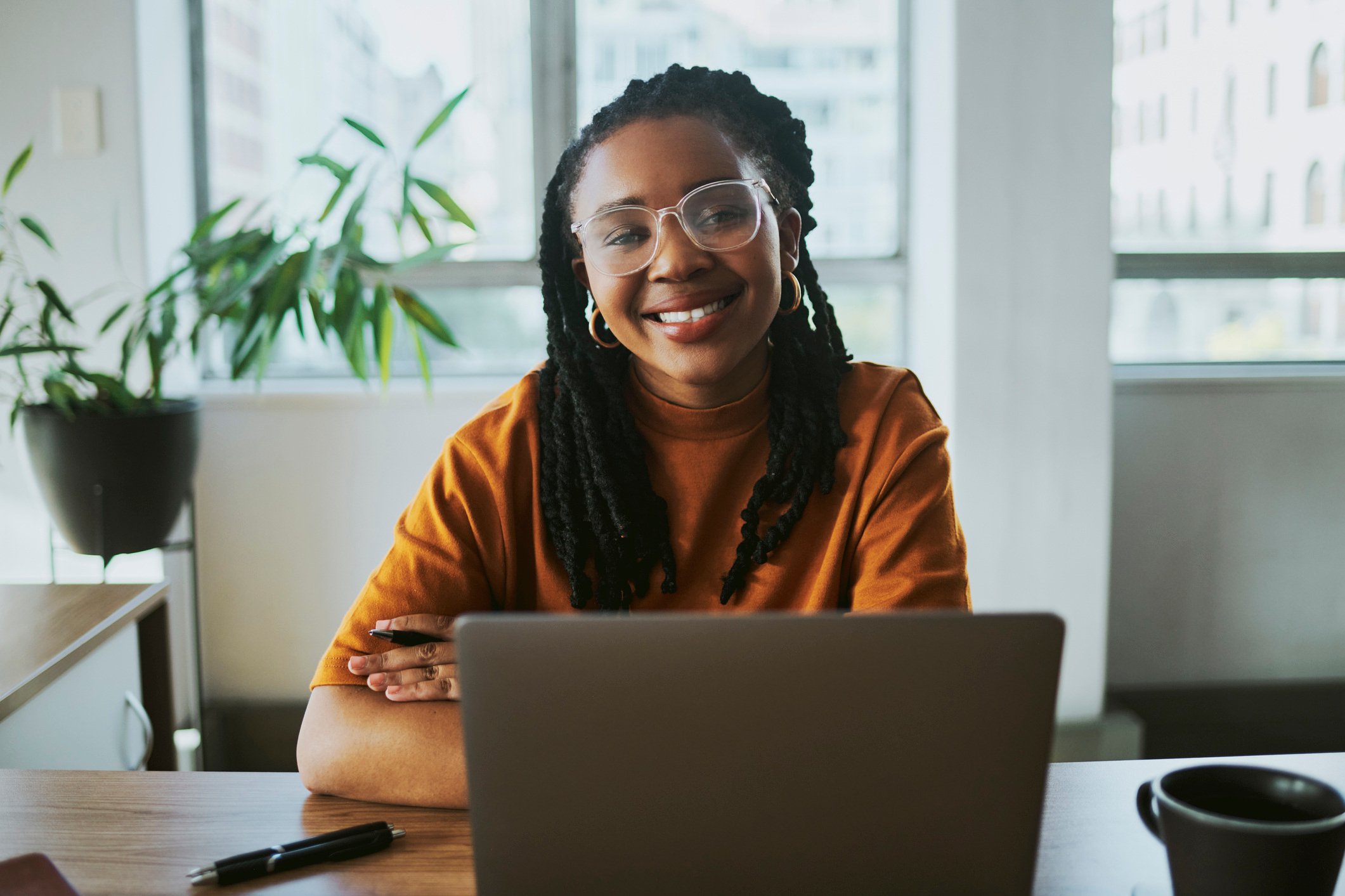 A desktop publishing expert works on a project with a smile.