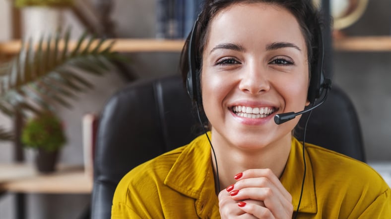 An interpreter smiles as she supports a call