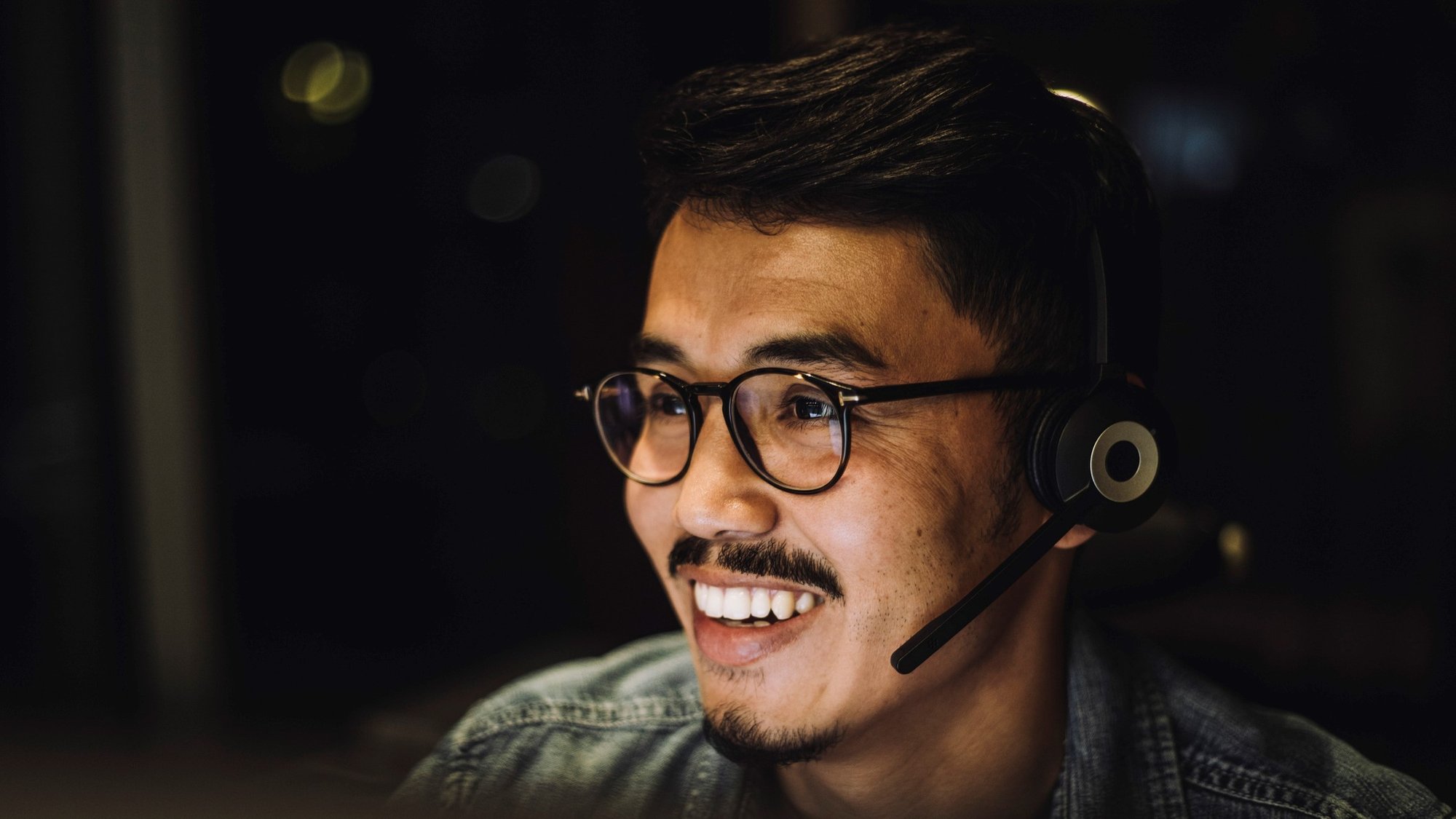 A linguist smiles as he works on a translation