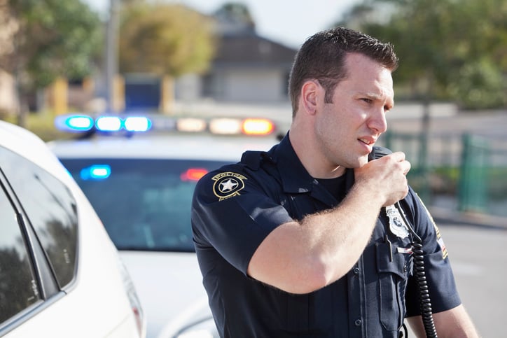 An officer radios in for language support