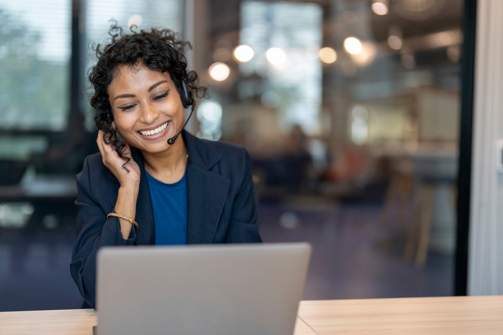 A LanguageLine representative smiles as she talks to a client