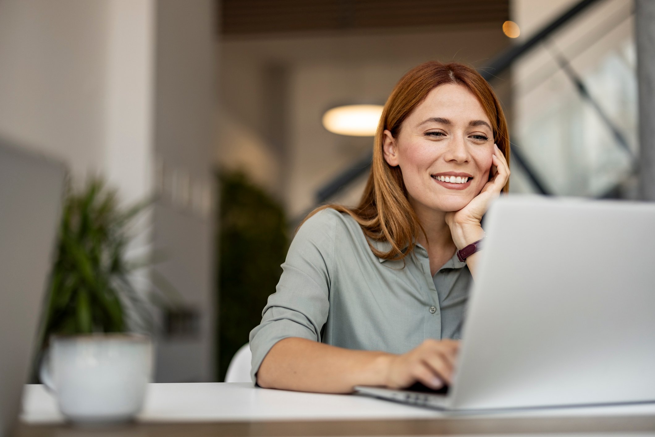 A client smiles as she reviews a translated document that was quickly turned around.