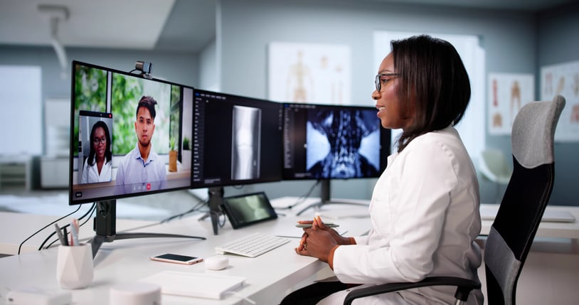 A doctor reviews test results with a patient through an interpreter during a telehealth call.