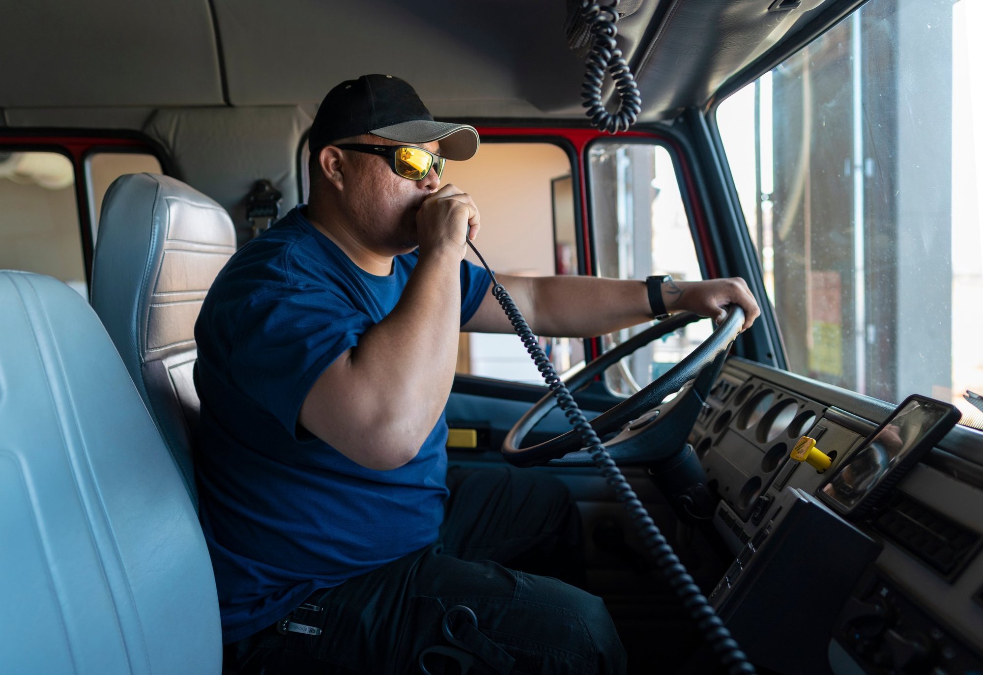 A man speaks into a CB in a truck