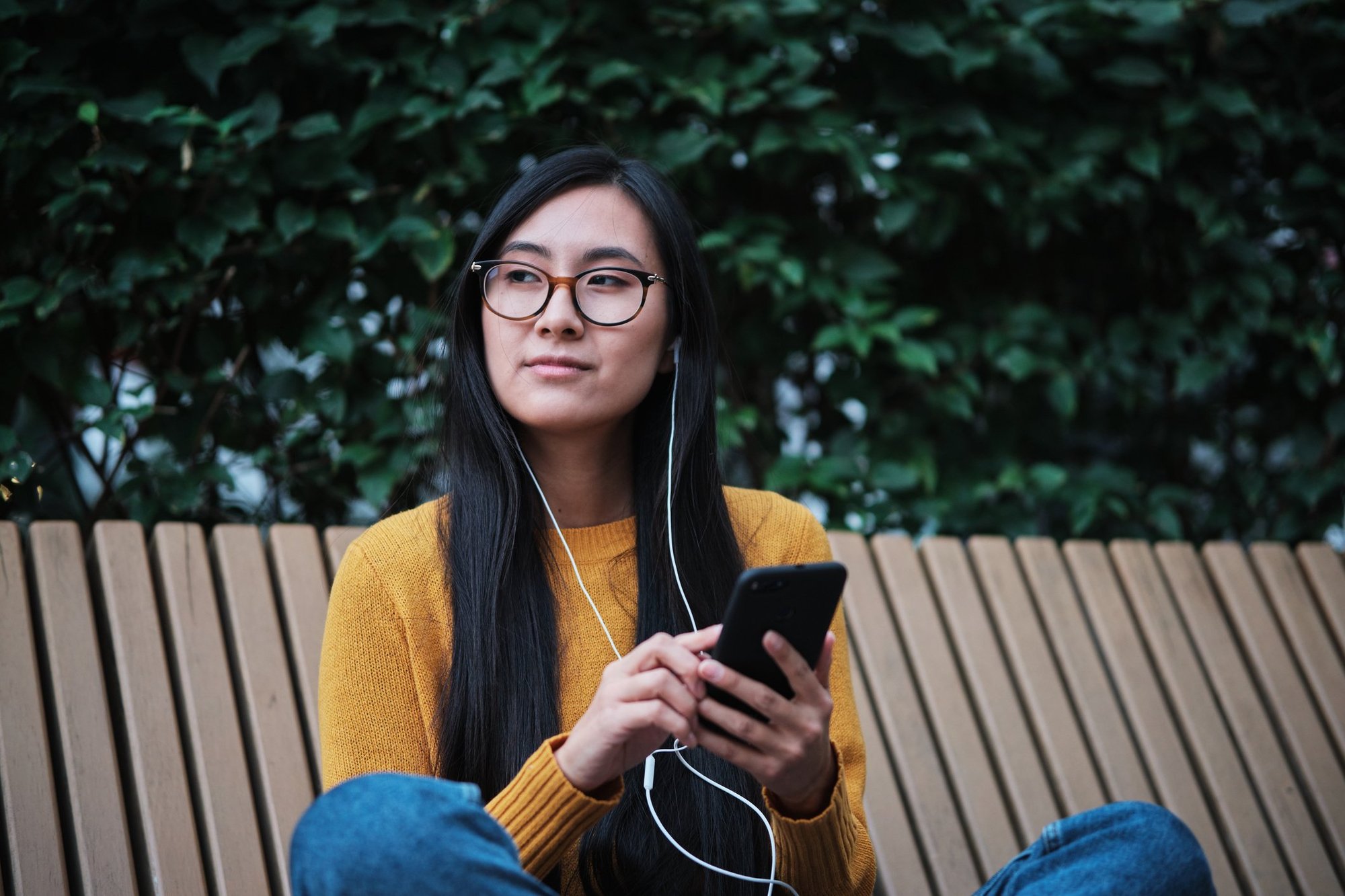 A woman listens to an audio transcription 