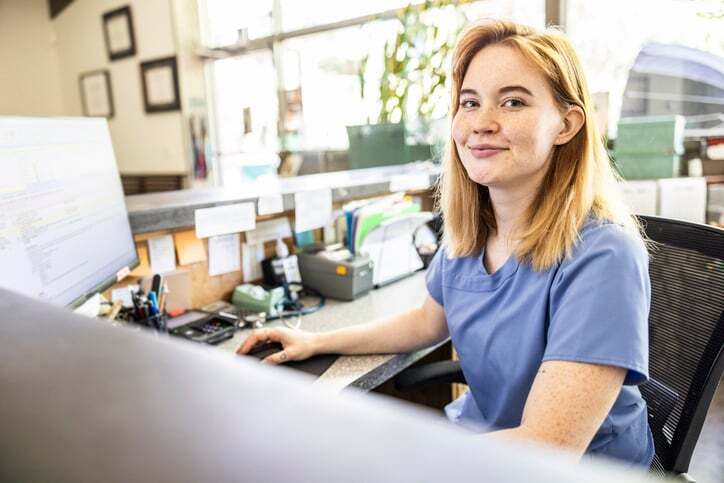 A healthcare worker smiles as she finishes an interpreted call.