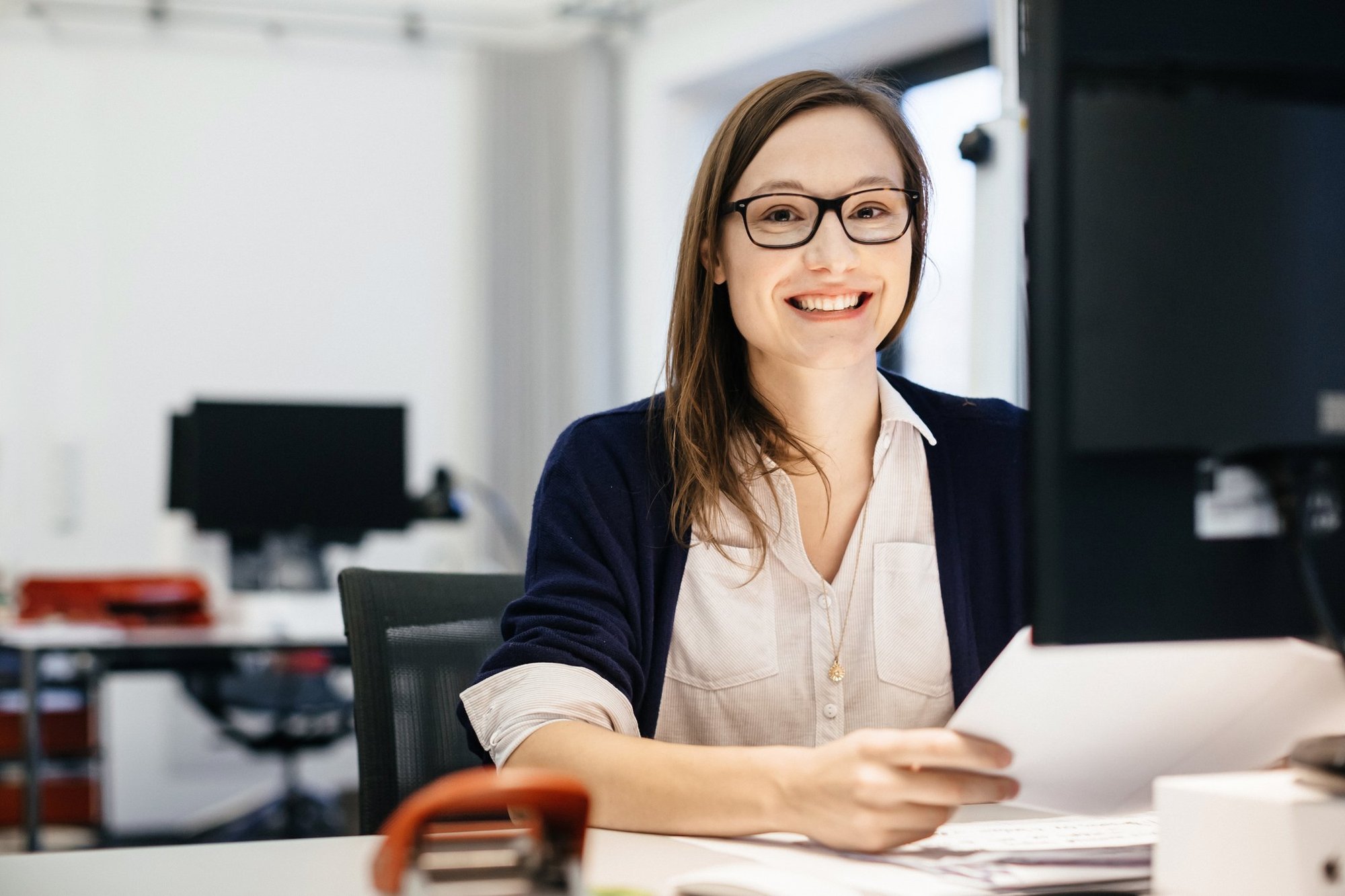 A customer smiles with satisfaction upon getting a translation project back.