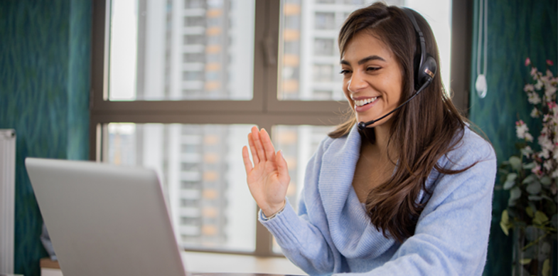 An interpreter greets a caller in a video session.