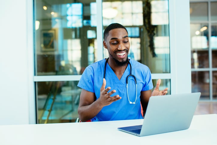 A doctor communicates with a patient in a telehealth call that includes an interpreter