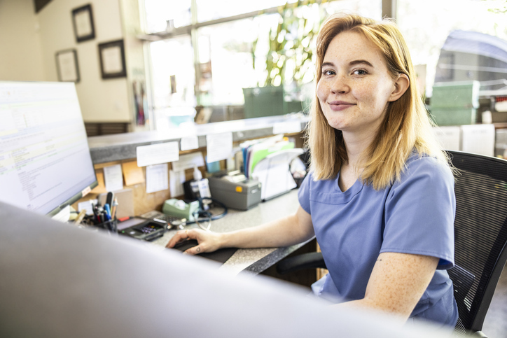 A healthcare worker smiles after submitting a translation request.