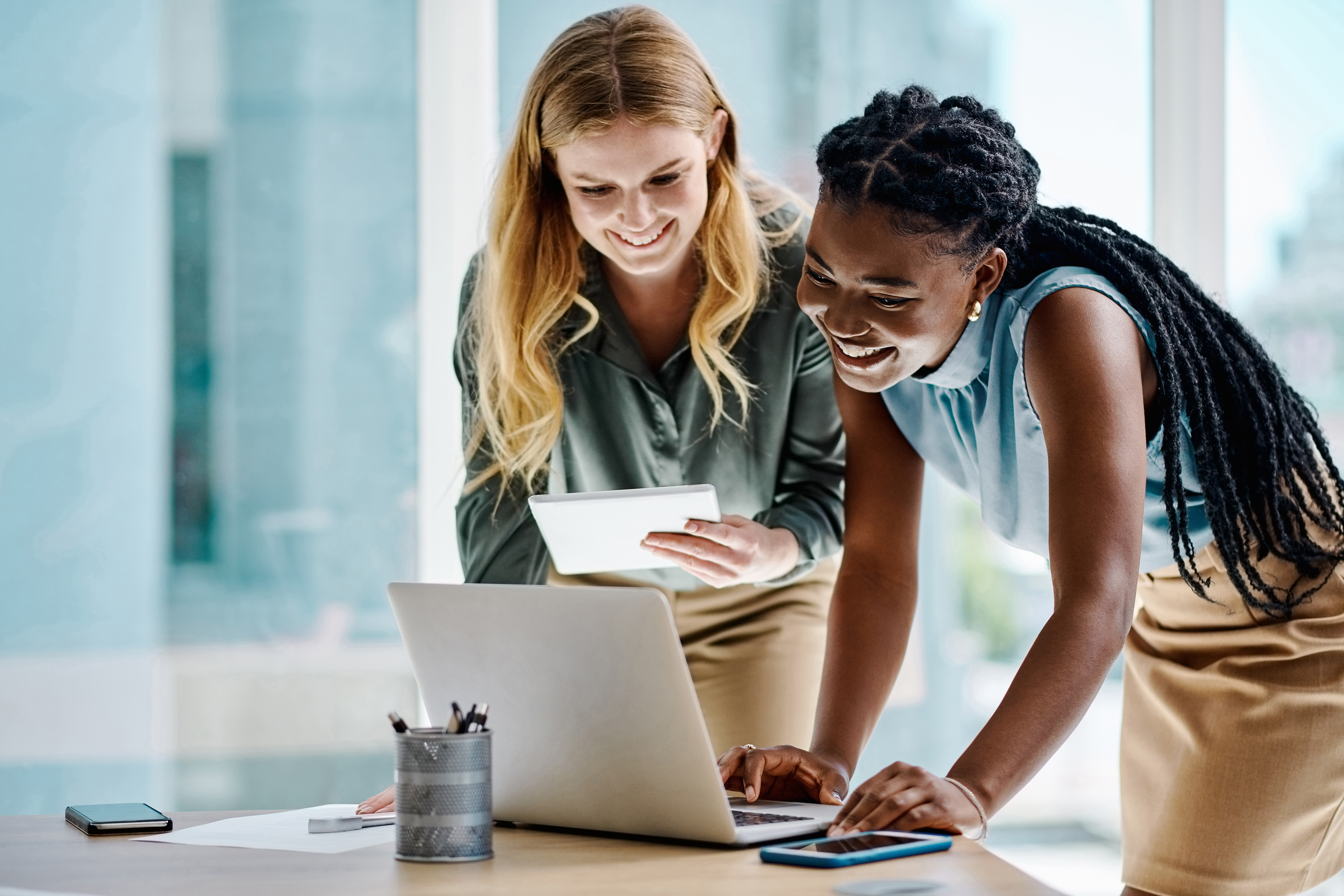 Two product developers review documentation together on a computer