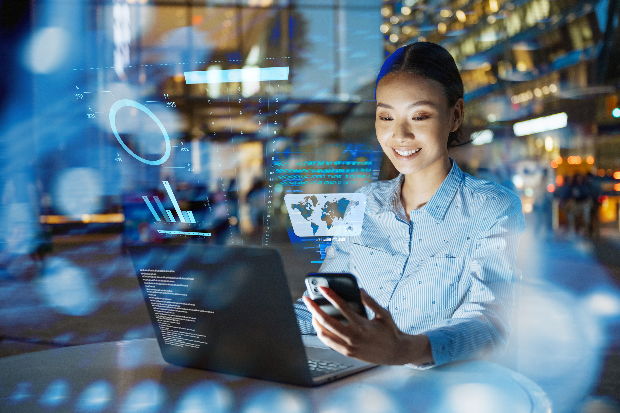 A woman smiles as she works on different technology platforms