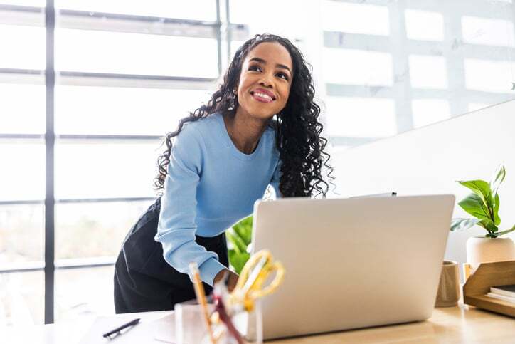 A customer smiles as she looks at their localised website