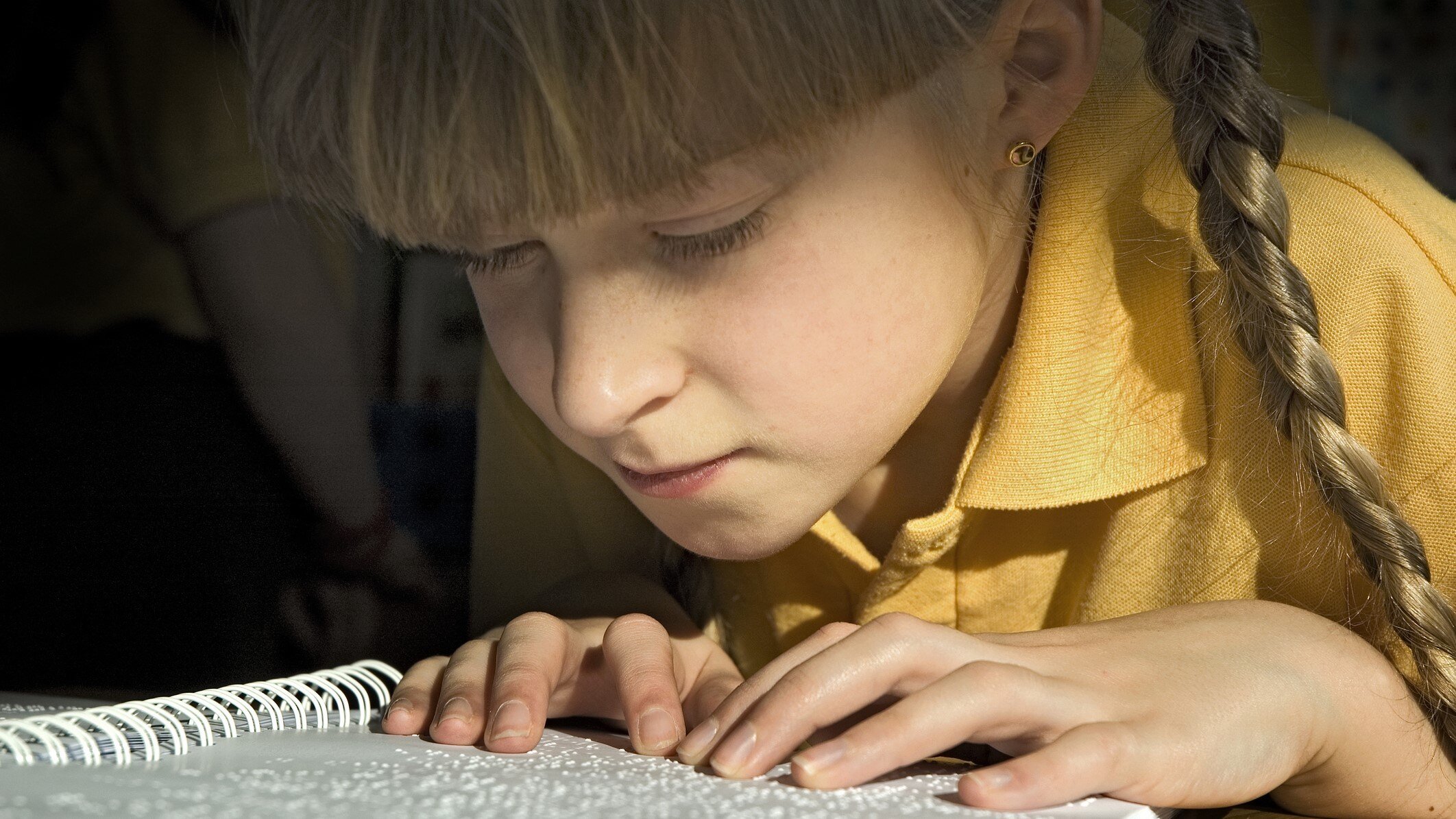 Girl reading Braille