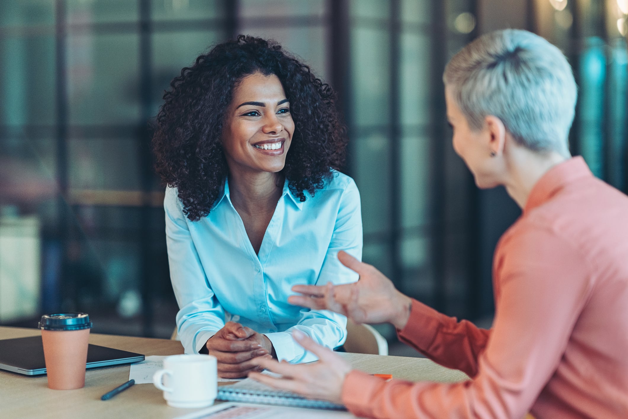 A lawyer and her client discuss legal documents that have been translated for clarity of understanding