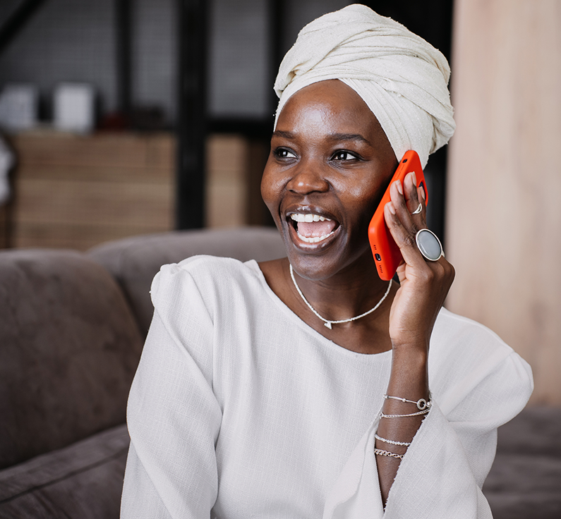 A happy limited English proficient caller speaks to an agent with an interpreter on the call after selecting her language from a menu.