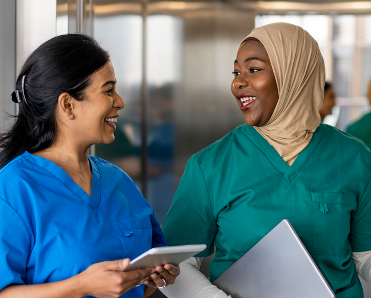 Two nhs workers laugh together